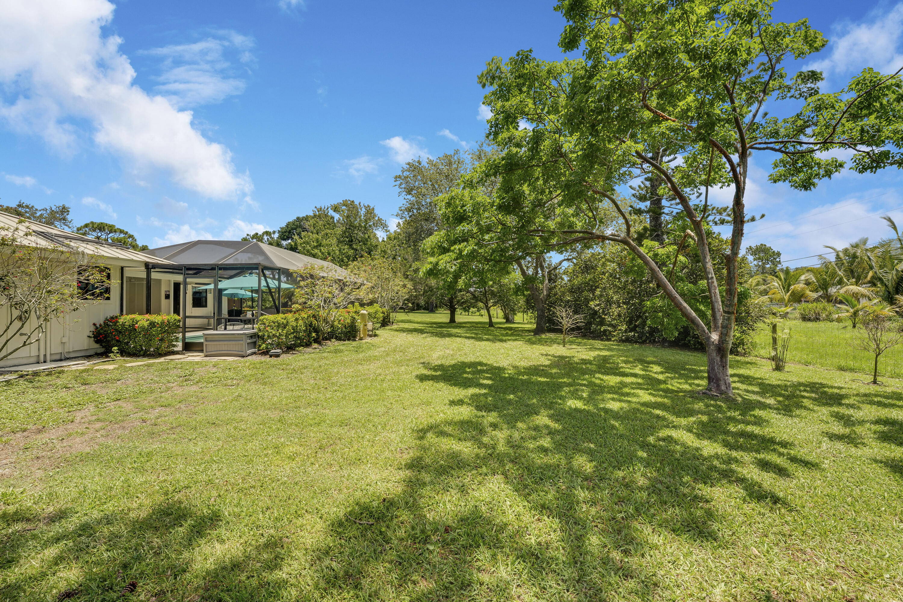 18784 Falcon Way Jupiter, FL 33458 - Photo 35 of 47 a yellow house with garden in front of it