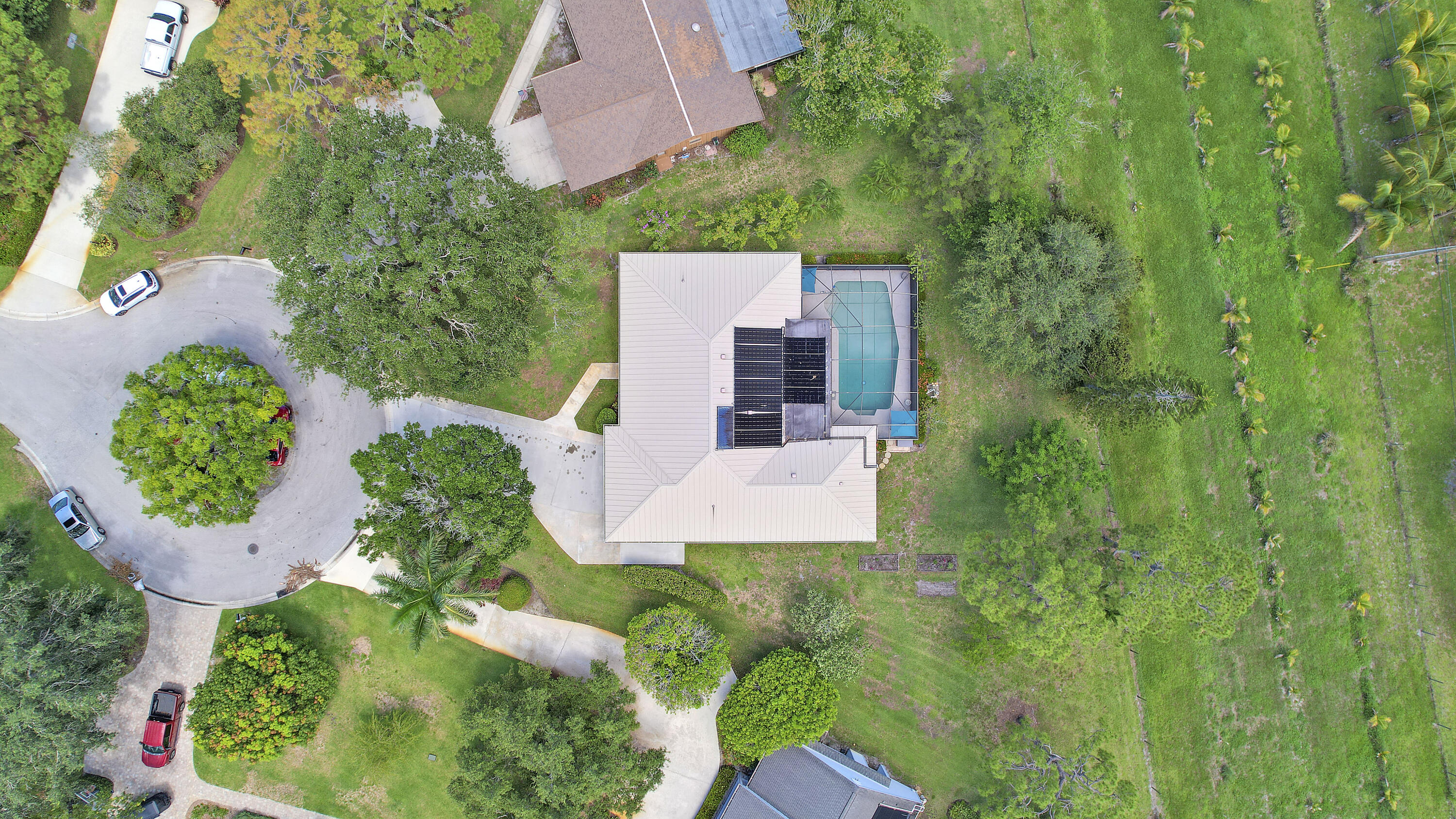 18784 Falcon Way Jupiter, FL 33458 - Photo 37 of 47 an aerial view of a house with a yard and trees