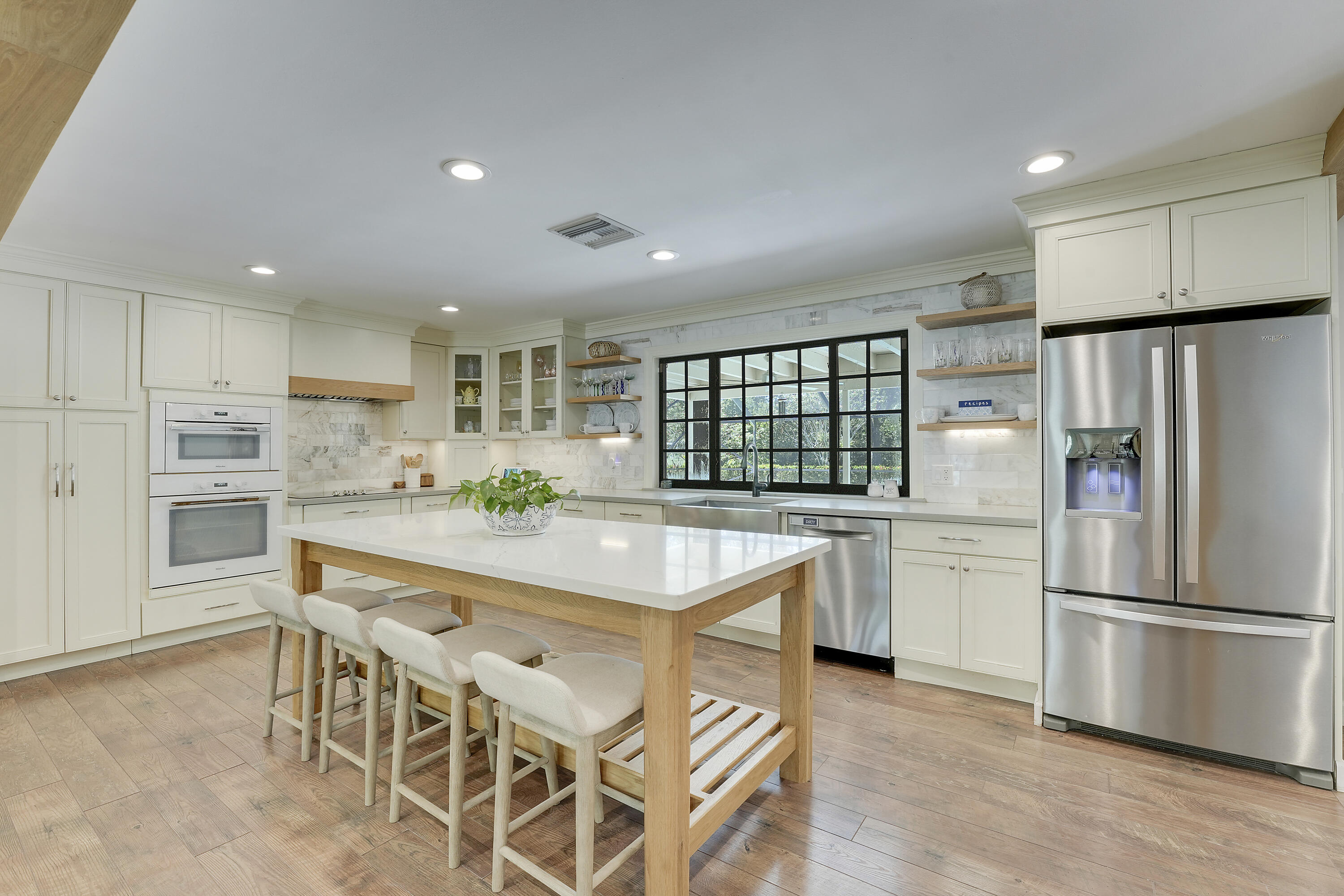 18784 Falcon Way Jupiter, FL 33458 - Photo 9 of 47 a kitchen with stainless steel appliances granite countertop a refrigerator and a stove top oven