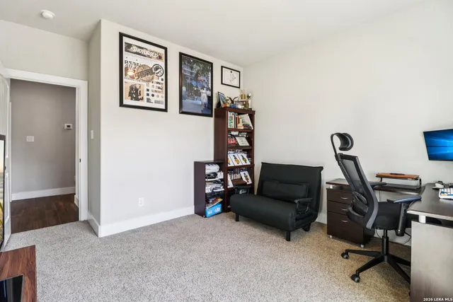a living room with furniture and a air conditioner vent