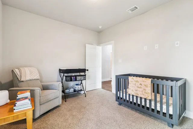 a bedroom with furniture and a baby crib