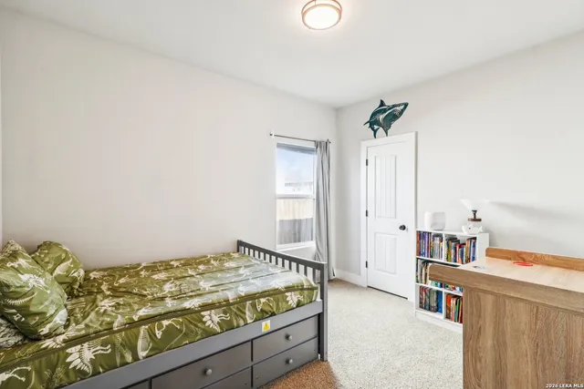 a bedroom with a bed and a book shelf