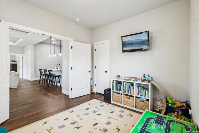 a bedroom with furniture and a book shelf