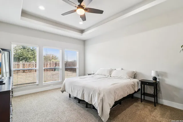 a spacious bedroom with a bed and a large window