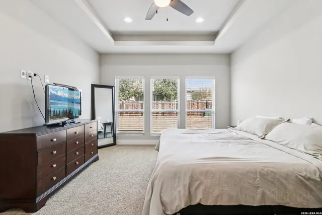 a bedroom with a large bed and a flat screen tv