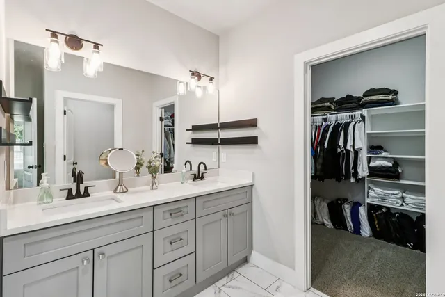 a bathroom with a double vanity sink and a mirror
