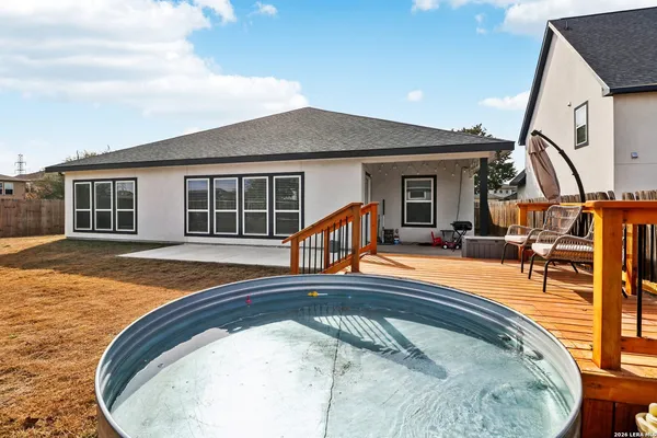 a view of a house with swimming pool and porch