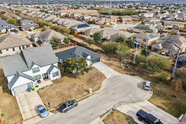 an aerial view of a house with a yard