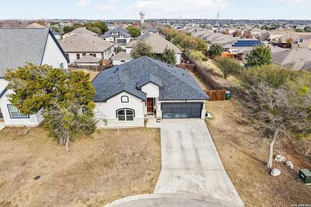 an aerial view of a house with a yard