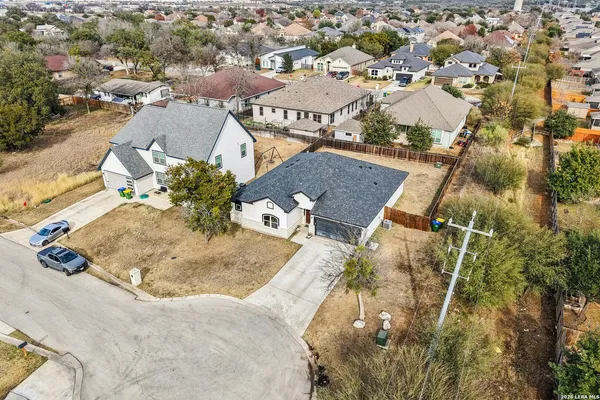 an aerial view of a house with a yard