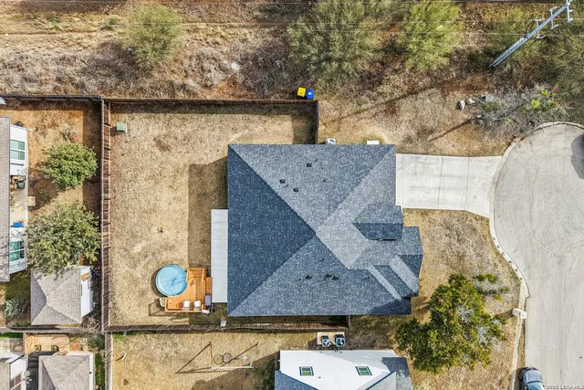 a aerial view of a house with garden space and a lake view