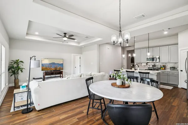 a dining room with furniture and wooden floor