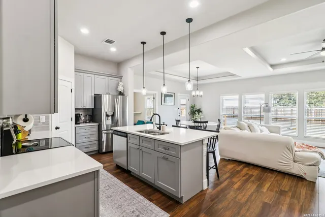 a room with stainless steel appliances a kitchen island sink stove and refrigerator
