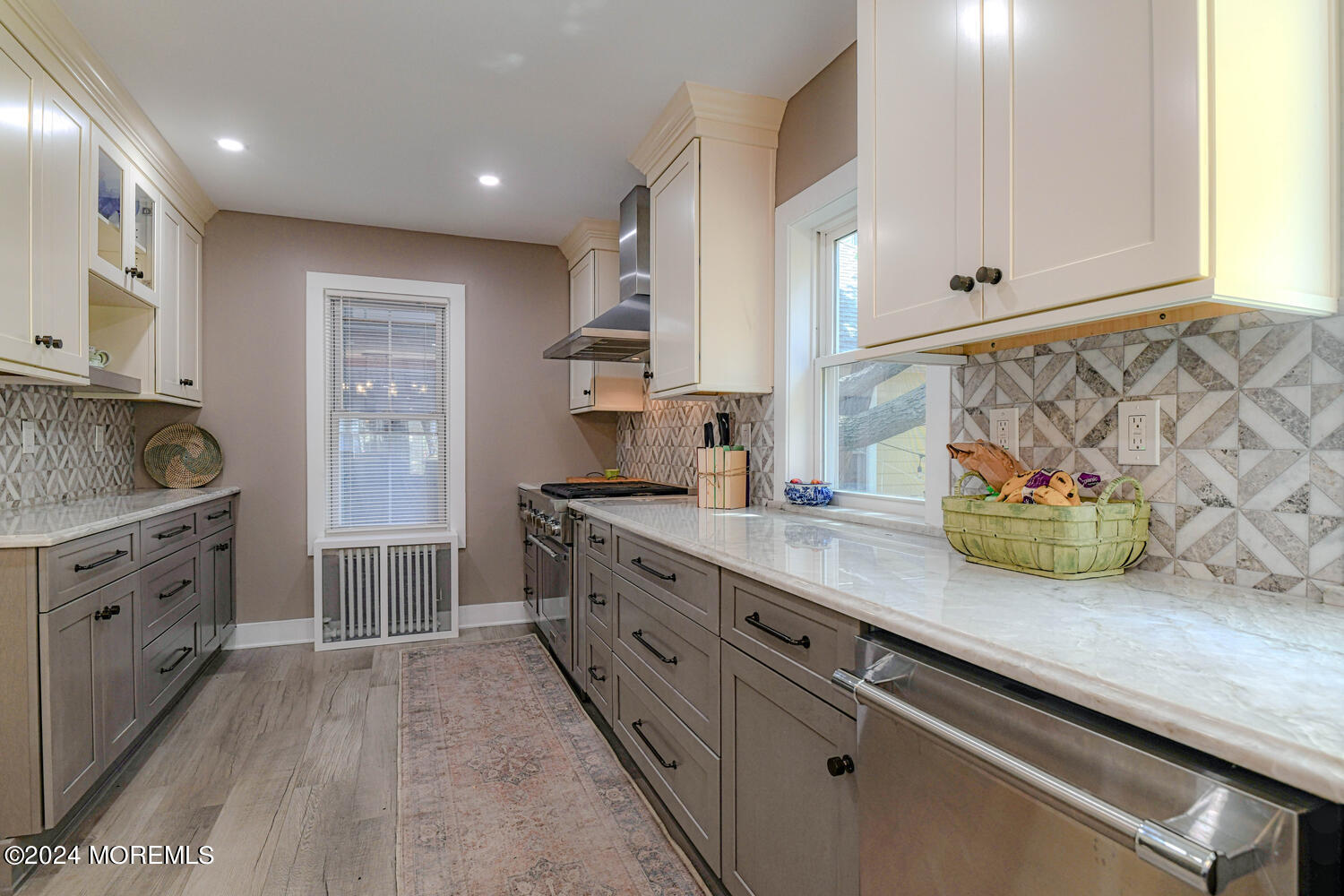 83 Broadway Ocean Grove, NJ 07756 - Photo 23 of 40 a kitchen with granite countertop white cabinets and white appliances