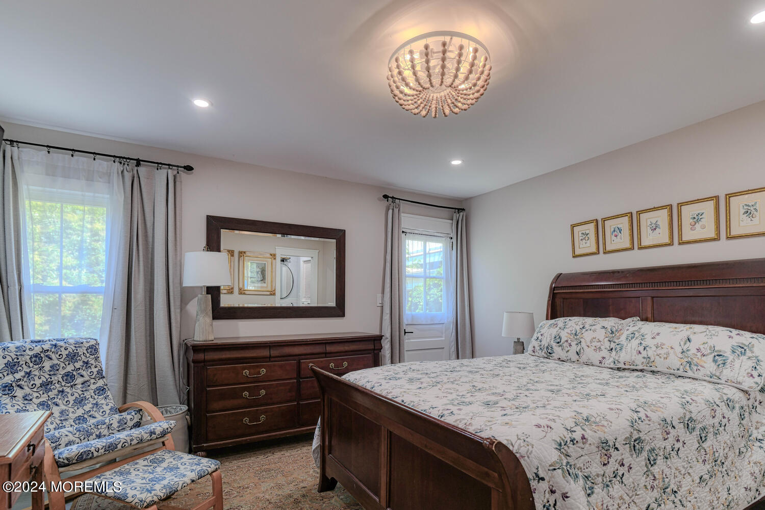83 Broadway Ocean Grove, NJ 07756 - Photo 26 of 40 a bedroom with a bed and a chandelier