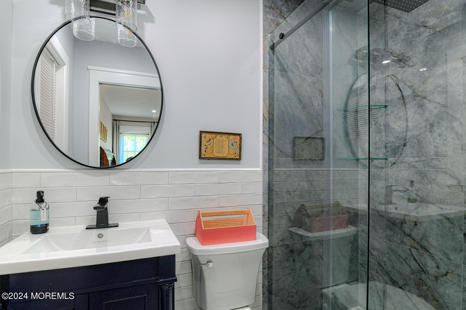 83 Broadway Ocean Grove, NJ 07756 - Photo 28 of 40 a bathroom with a sink a toilet and a mirror