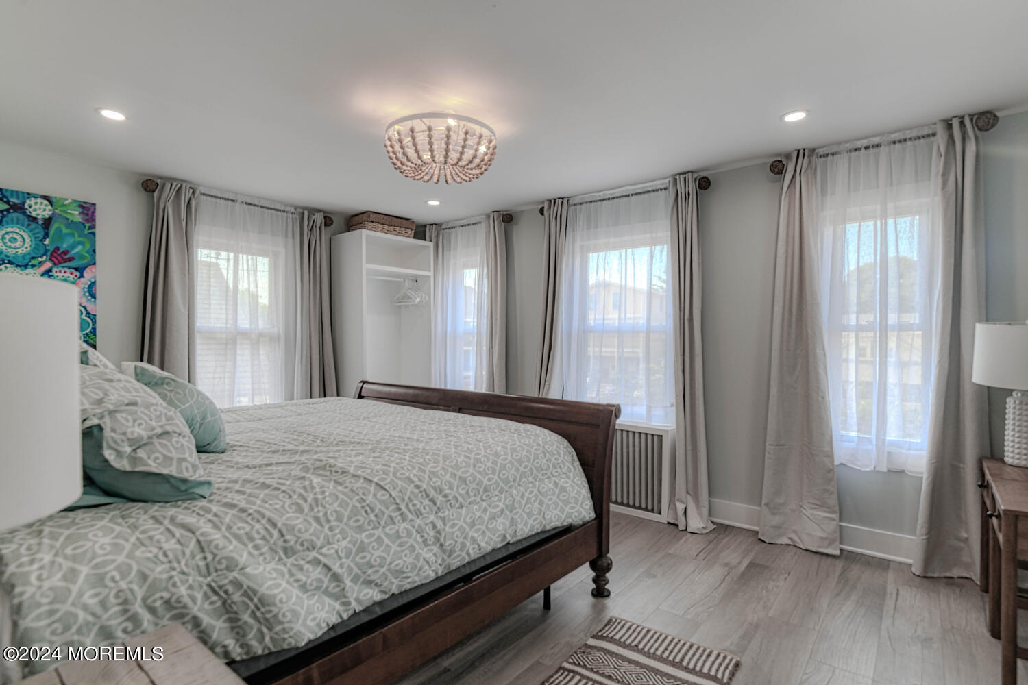 83 Broadway Ocean Grove, NJ 07756 - Photo 29 of 40 a bedroom with a large bed and a chandelier