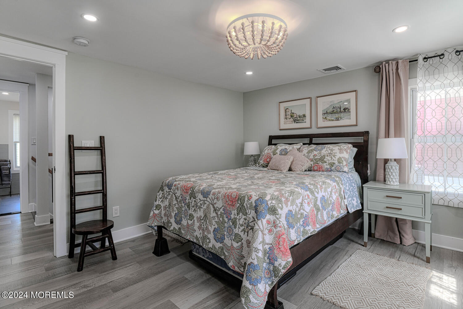 83 Broadway Ocean Grove, NJ 07756 - Photo 32 of 40 a bedroom with a bed and a chandelier