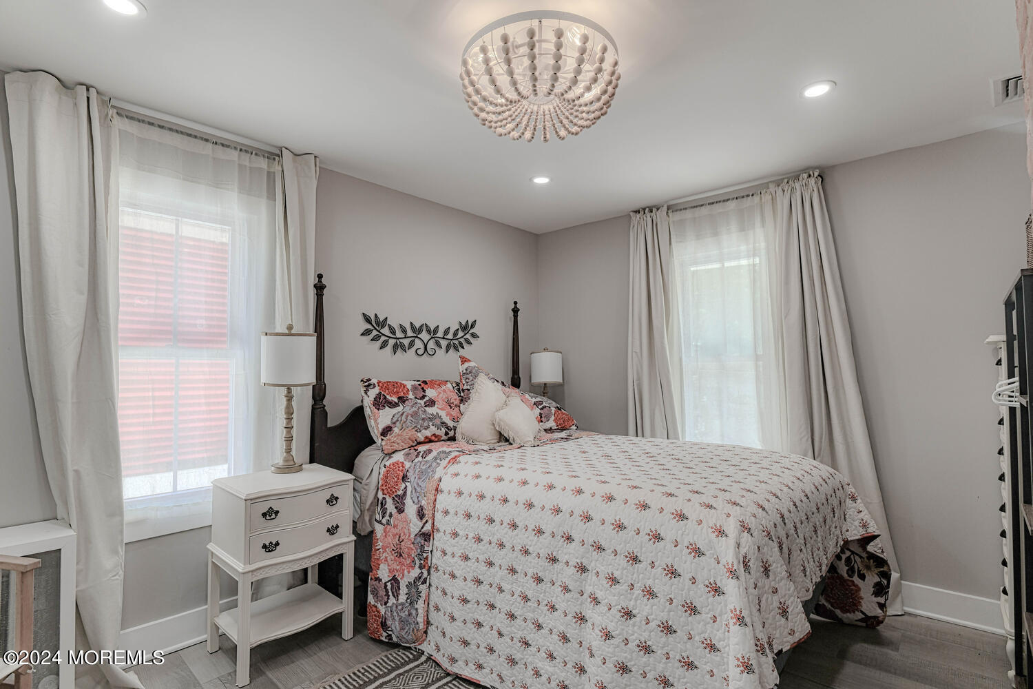 83 Broadway Ocean Grove, NJ 07756 - Photo 33 of 40 a bedroom with a large bed and a chandelier