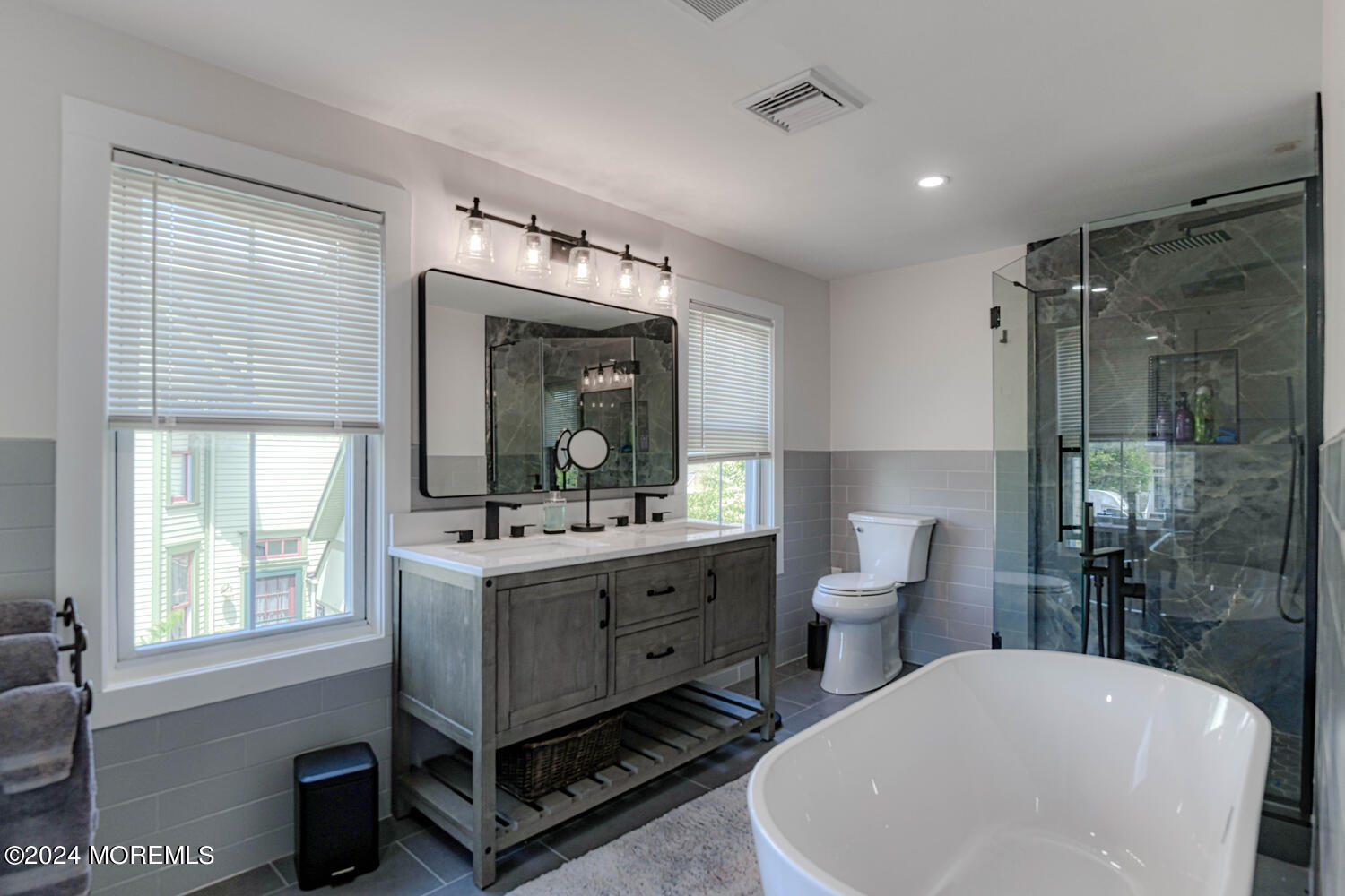 83 Broadway Ocean Grove, NJ 07756 - Photo 35 of 40 a bathroom with a sink double vanity and a mirror