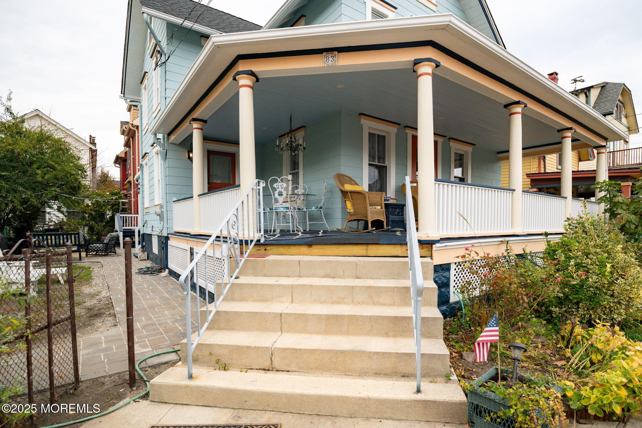 83 Broadway Ocean Grove, NJ 07756 - Photo 4 of 40 a view of a white house with large windows and a table and chairs