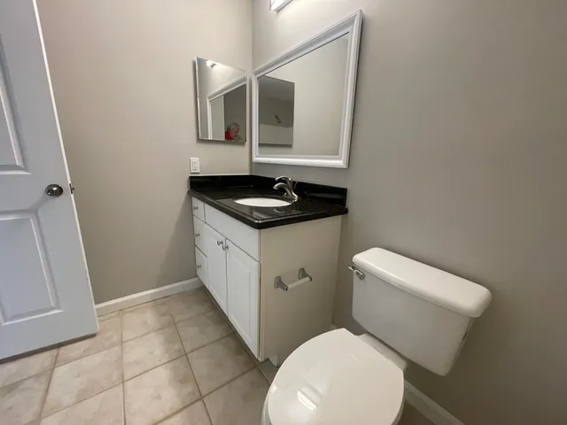 a white toilet sitting next to a bathroom sink