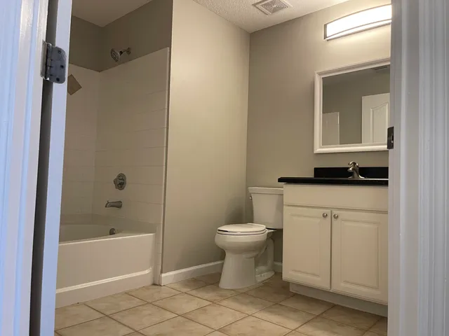 a bathroom with a toilet sink and shower