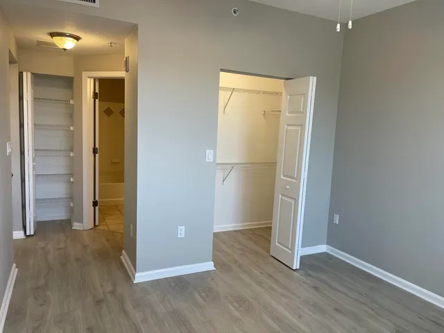 an empty room with wooden floor and a window