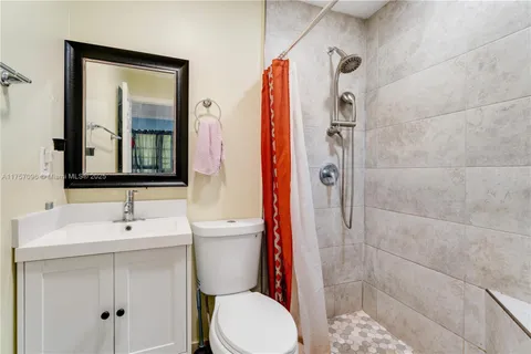 a bathroom with a toilet sink and shower