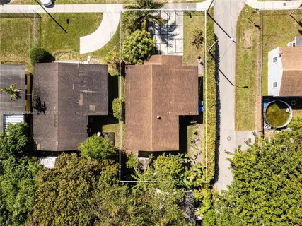 an aerial view of a house with a yard