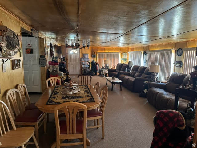 123 North 3rd Manila, UT 84046 - Photo 7 of 15 Open concept living area with wood paneling and a dining space