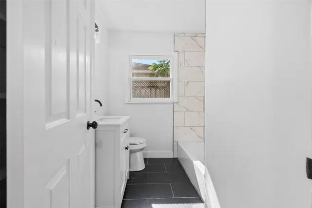 a kitchen with cabinets stainless steel appliances a sink and a stove