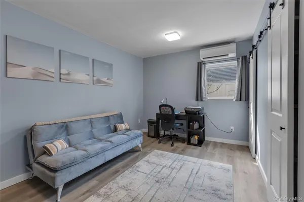 a view of a livingroom with a fireplace a chandelier and stairs
