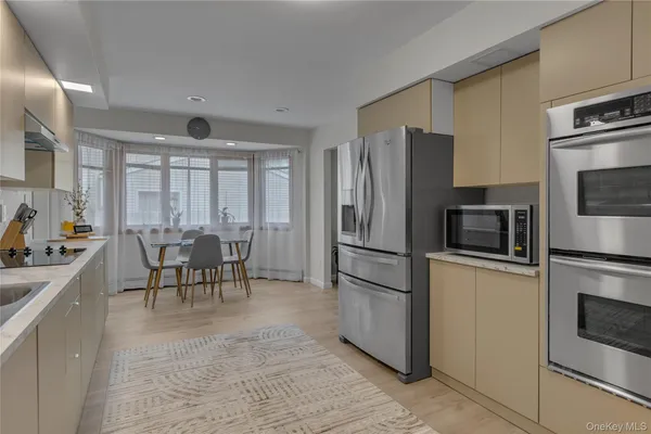 a kitchen with counter top space and dining table
