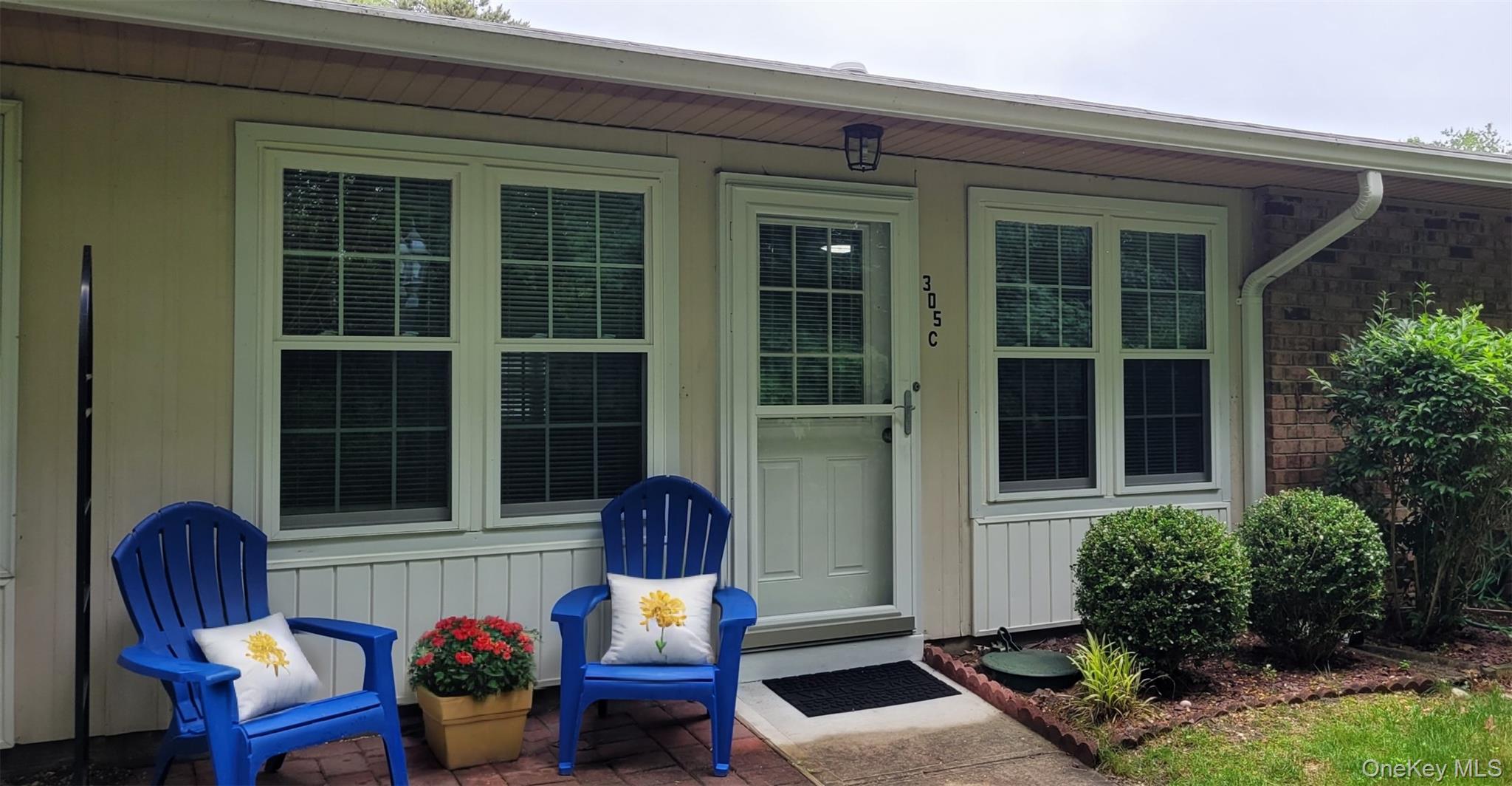 a view of a house with a chairs in patio