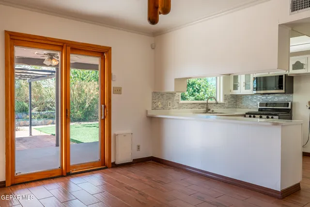 a kitchen with stainless steel appliances granite countertop a refrigerator a stove top oven a sink and dishwasher