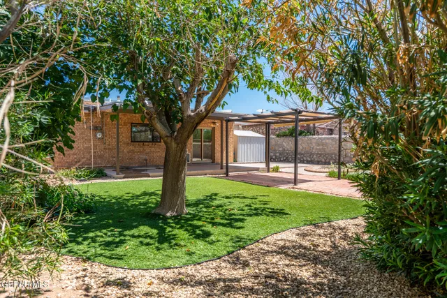 a view of a house with a yard and pathway