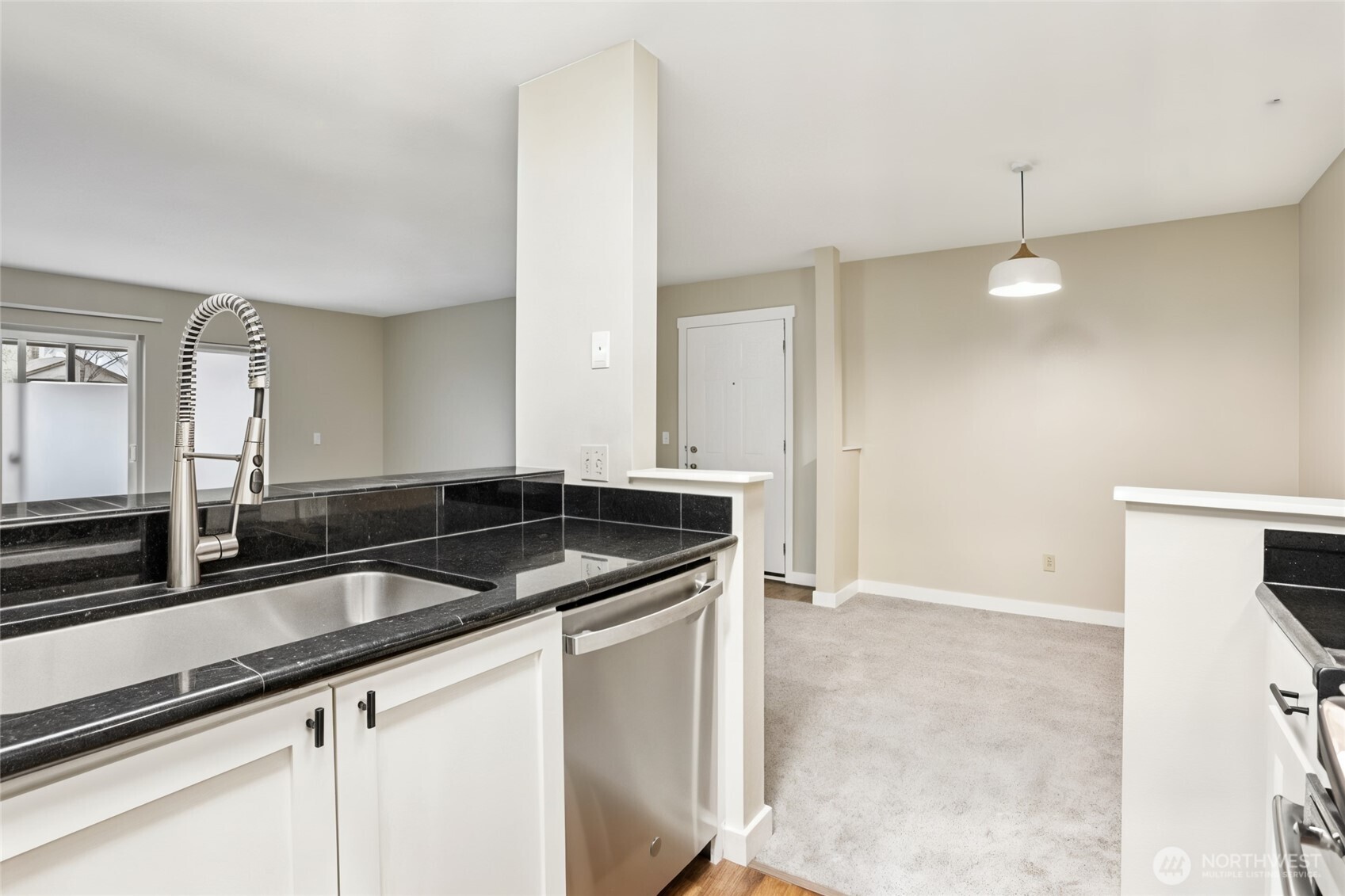 12303 Harbour Pointe Boulevard, Unit W101 Mukilteo, WA 98275 - Photo 12 of 25 a kitchen with granite countertop a sink and a refrigerator