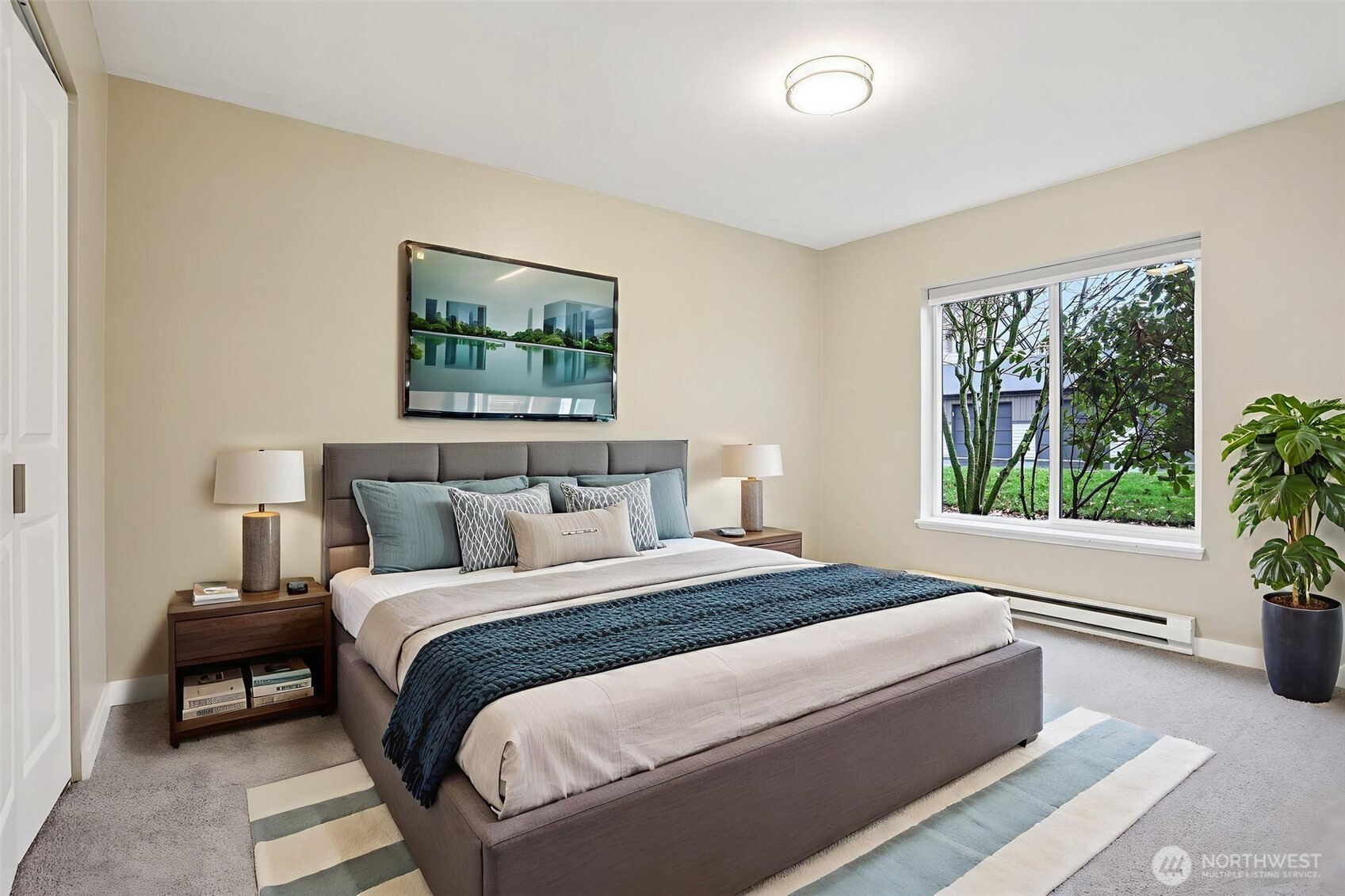 12303 Harbour Pointe Boulevard, Unit W101 Mukilteo, WA 98275 - Photo 17 of 25 a bedroom with a bed and a painting on the wall