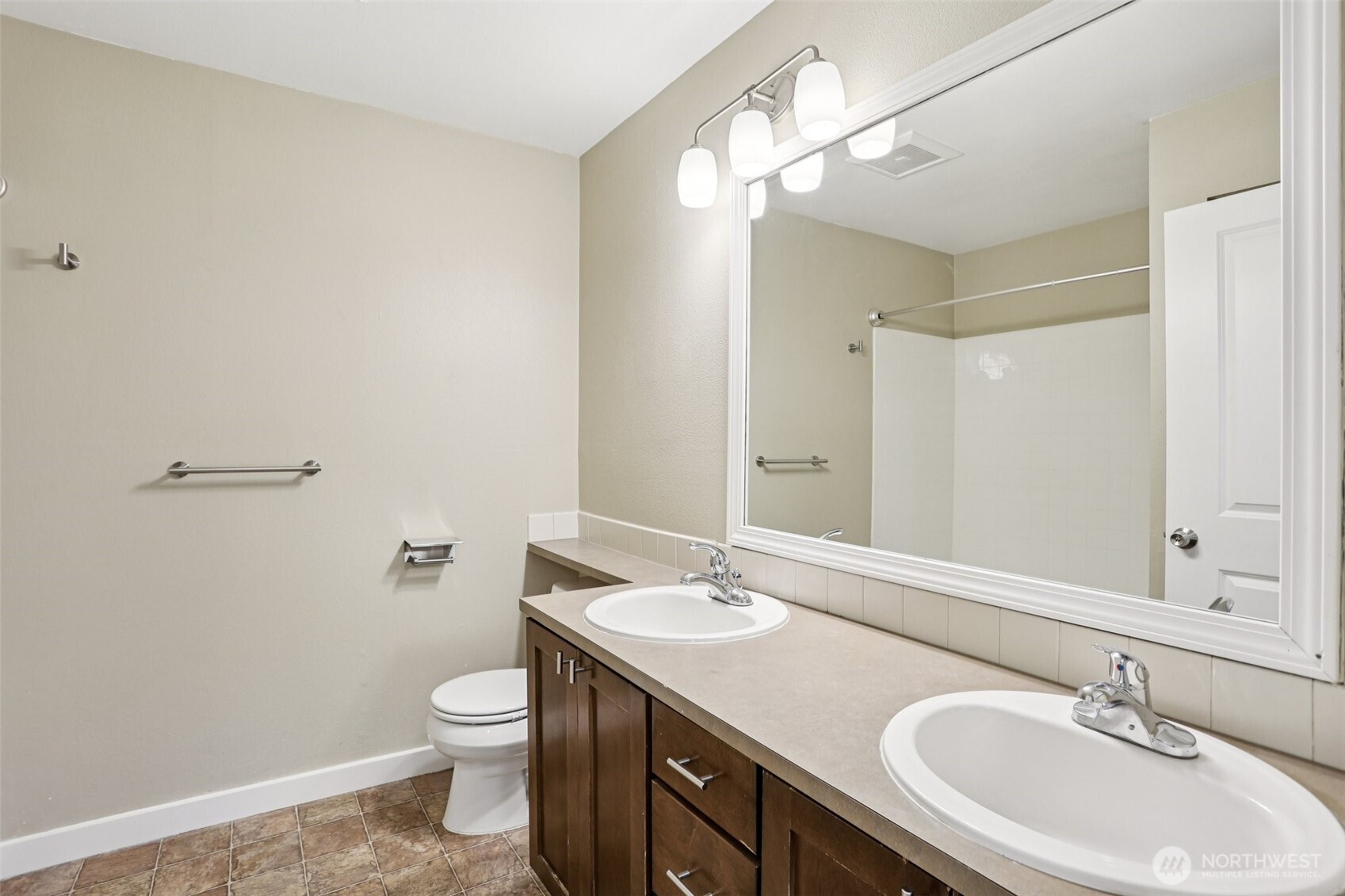 12303 Harbour Pointe Boulevard, Unit W101 Mukilteo, WA 98275 - Photo 21 of 25 a bathroom with a toilet a sink a mirror and a shower
