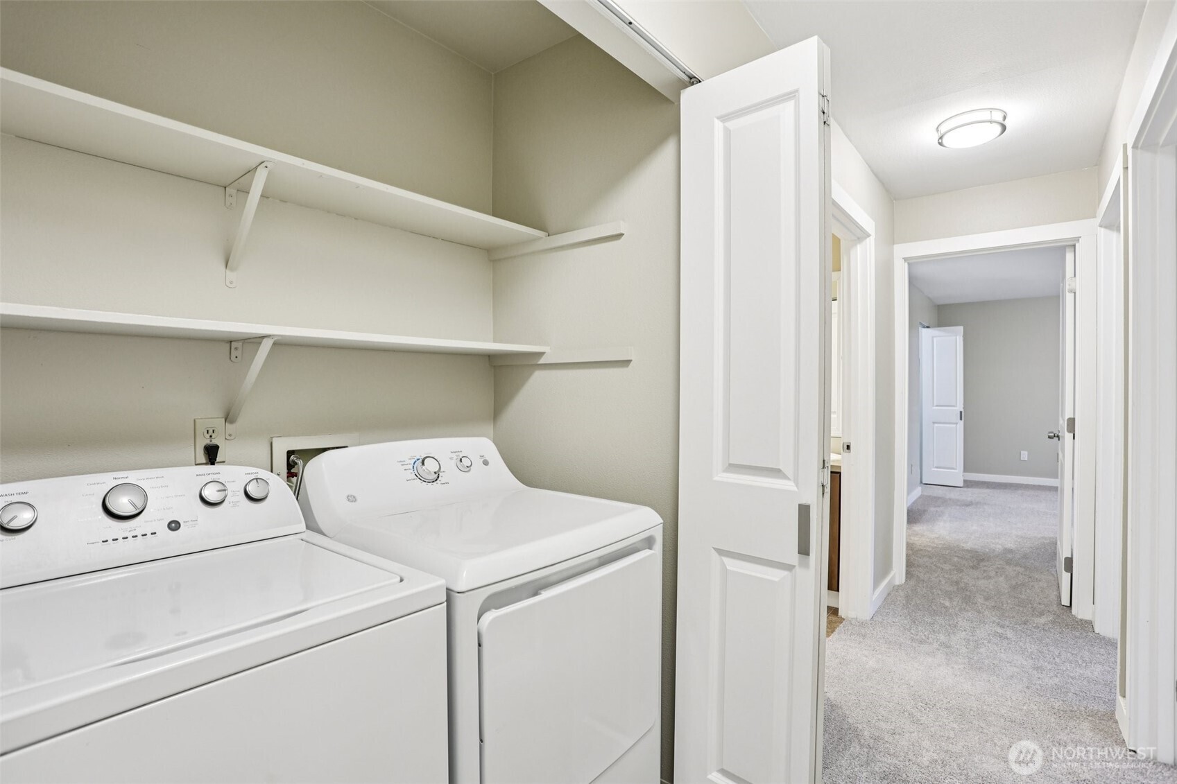 12303 Harbour Pointe Boulevard, Unit W101 Mukilteo, WA 98275 - Photo 22 of 25 a view of washer and dryer with kitchen in the background