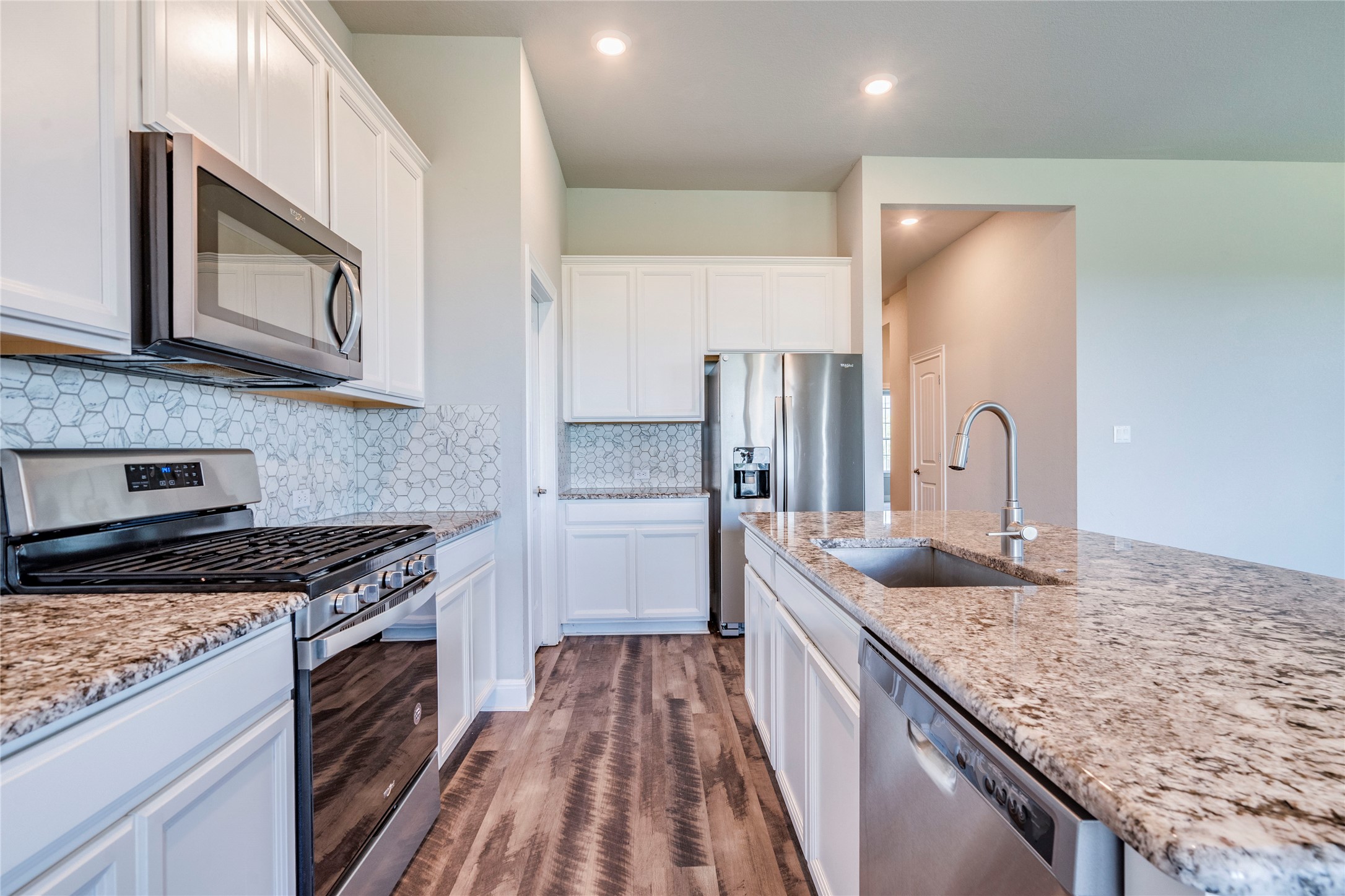 130 Sierra Blanca Road Dripping Springs, TX 78620 - Photo 11 of 24 a kitchen with stainless steel appliances granite countertop a sink stove and refrigerator
