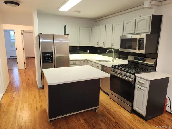 a kitchen with stainless steel appliances a refrigerator stove and microwave