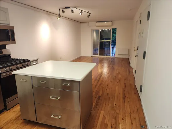 a kitchen with a sink and wooden floor