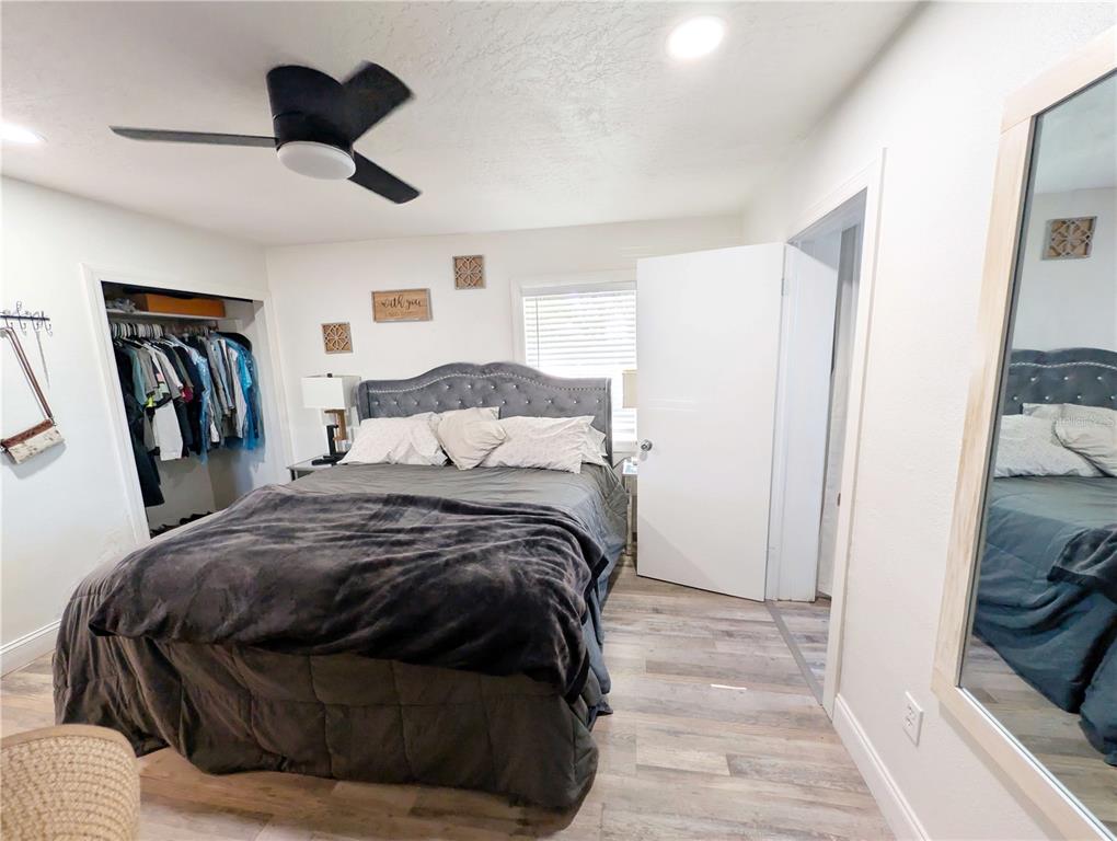 1007 77th Street East Palmetto, FL 34221 - Photo 11 of 39 a bedroom with a bed and wooden floor