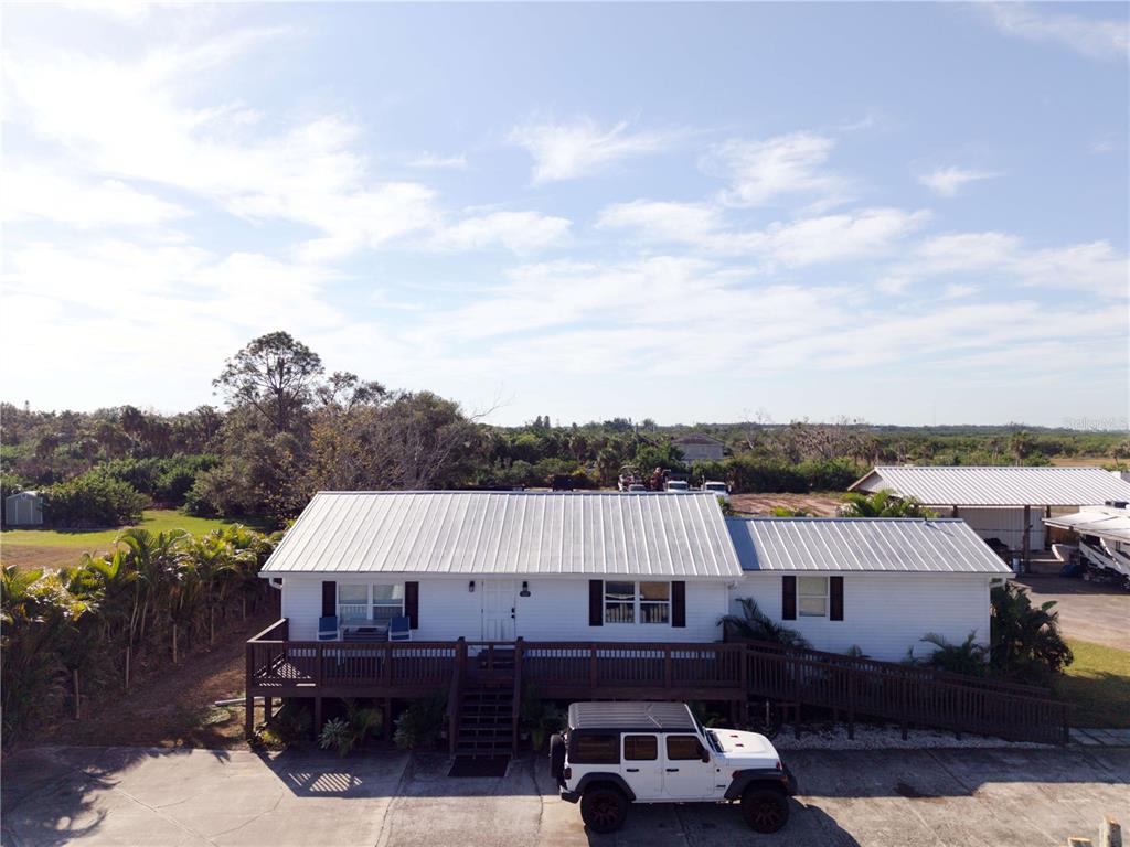 1007 77th Street East Palmetto, FL 34221 - Photo 2 of 39 an aerial view of a house with roof deck outdoor seating and city view