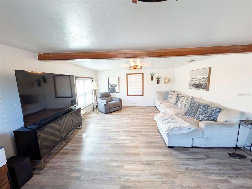 1007 77th Street East Palmetto, FL 34221 - Photo 8 of 39 a living room with furniture and a flat screen tv