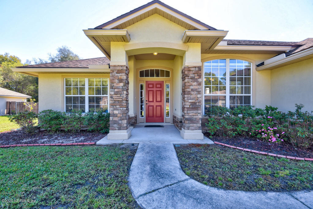 97071 Castle Ridge Drive Yulee, FL 32097 - Photo 1 of 26 a front view of a house with garden