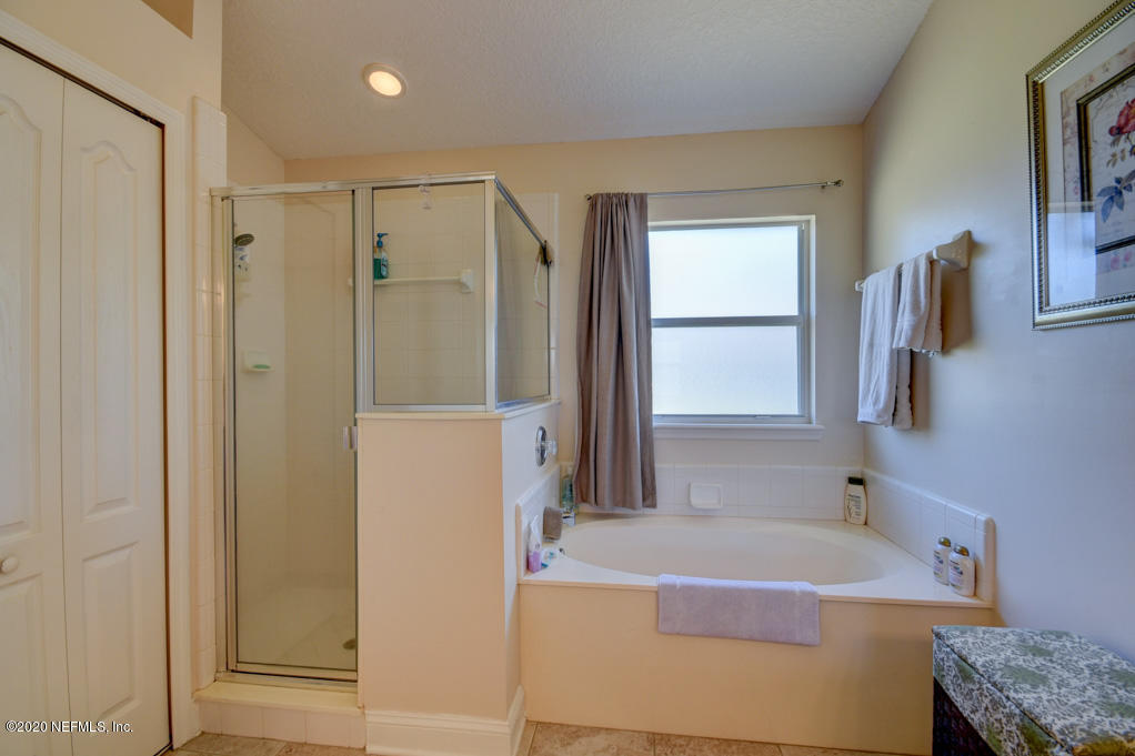 97071 Castle Ridge Drive Yulee, FL 32097 - Photo 15 of 26 a bathroom with a tub sink and mirror