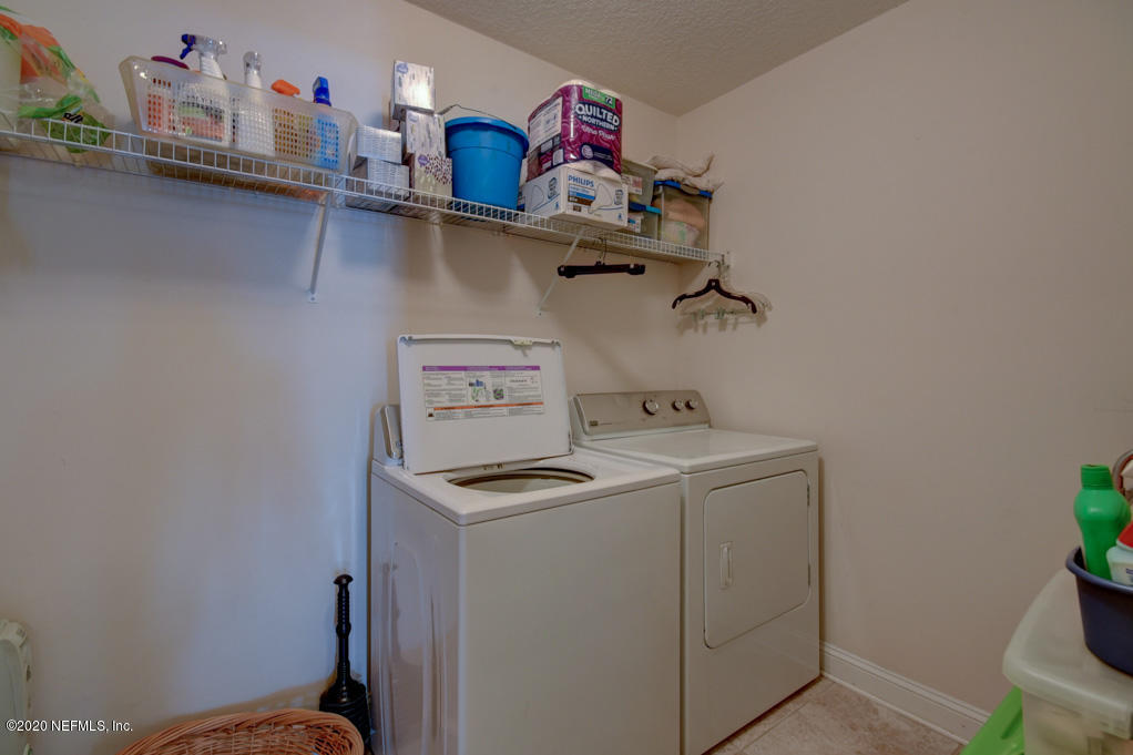 97071 Castle Ridge Drive Yulee, FL 32097 - Photo 18 of 26 a utility room with dryer washer and shoe rack